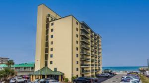 a tall building with cars parked in a parking lot at Ocean Front Penthouse with Incredible Views! Sunglow Resort 1003 by Brightwild in Daytona Beach Shores