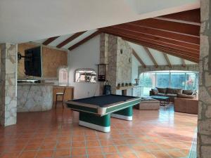 a large living room with a pool table in it at Casa con alberca in San Agustín