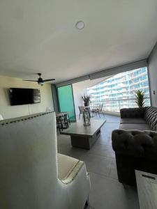 ヌエボ・バジャルタにあるDepartamento Frente al Mar Ariaのソファとテーブルのあるリビングルーム