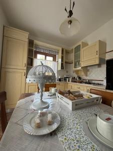 a kitchen with a table with plates on it at Sosta in Sila in Spezzano Piccolo +6 photos