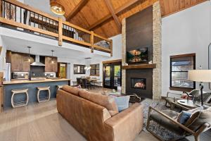 a living room with a couch and a fireplace at Beautiful Views! Jacuzzi, Indoor/ Outdoor Fireplace, Steps to Lake Estes in Estes Park