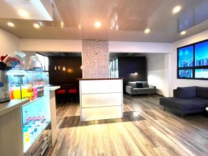 a living room with a refrigerator and a couch at Lavid Hotel Kennedy in Bogotá +53 photos
