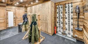 a room with wooden walls with ski equipment in it at Chalet Paradis Blanc - Chalet 4 - 129m2 - 6 chambres, 6 salles de bain MAE-2024 in Tignes