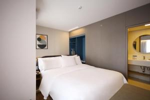 Letto o letti in una camera di Clarion Faria Lima