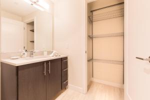 a bathroom with a sink and a mirror at Bright & Modern Apt Downtown Seaport in Boston
