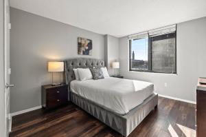 a bedroom with a large bed and a window at Modern Apt Near Downtown in White Plains