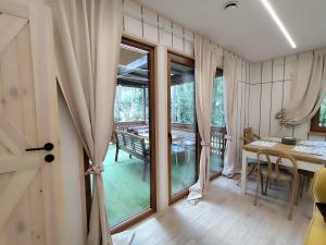 a room with a table and a dining room at Jutowa Chata - nocleg bliżej natury in Łask +42 photos