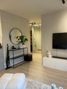 a living room with a flat screen tv on a wall at Plaza Havstad in Trondheim