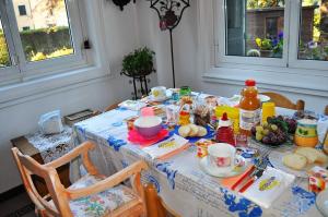 a table with a table cloth with food on it at Invilla B&B in Varese