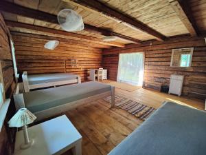 a room with two beds in a log cabin at Rustic Country Retreat With Private Sauna in Leie +11 photos