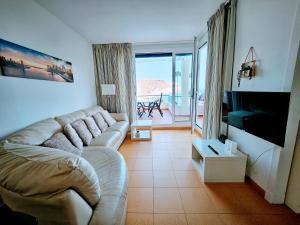 a living room with a couch and a television at Wonderful Ocean View in Playa del Cura