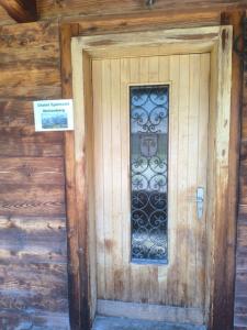 a wooden door with a sign in front of it at Chalet Spillstatt in Grindelwald
