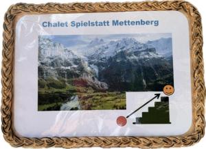 a plaque with a picture of a mountain at Chalet Spillstatt in Grindelwald