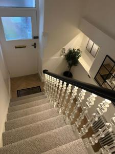 a stairway with a potted plant sitting on top of it at Luxury High Street Apartment in Moffat +23 photos