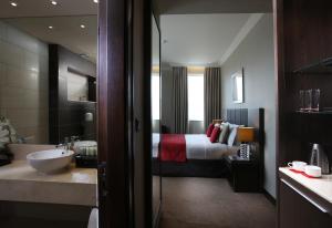 A bed or beds in a room at Ramada Downtown Abu Dhabi
