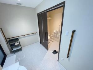 a room with a bathroom with a toilet and a door at Seaside house & Terrace SEAGULL - Vacation STAY 80511v in Towa +15 photos