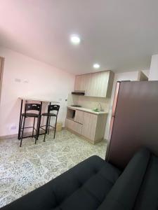 a kitchen with two chairs and a table in a room at Céntrico Familiar Vive y disfruta Medellín 107 in Medellín