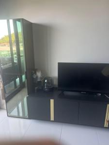a flat screen tv sitting on top of a cabinet at Konak premium Seaside Studio in Kargicak