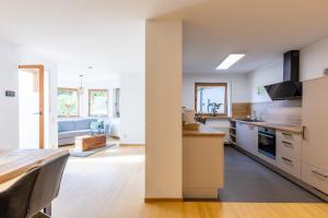 a kitchen with a table and a dining room at Hambach Waldschlössl in Neustadt an der Weinstraße
