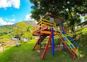 a playground with a colorful slide in a park at Flat HOTEL Pedra do Rodeadouro 1 andar in Bonito