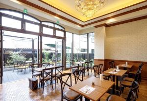 a restaurant with wooden tables and chairs and windows at FIVE HOTEL OSAKA - Vacation STAY 72912v in Osaka