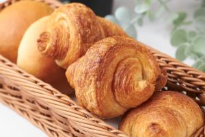 a basket filled with croissants and other pastries at FIVE HOTEL OSAKA - Vacation STAY 72912v in Osaka
