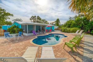 a patio with a pool and chairs and a house at Sand Dollar Studio Pool Daily Rentals in Sarasota