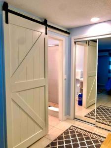 a sliding barn door in a room with a hallway at Sand Dollar Studio Pool Daily Rentals in Sarasota +37 photos