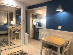 a kitchen and dining room with a table and chairs at Sand Dollar Studio Pool Daily Rentals in Sarasota