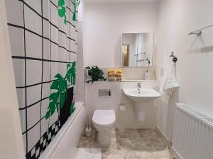 a white bathroom with a toilet and a sink at Issara Apartments 49 - Great location & Private Parking in Portsmouth +23 photos