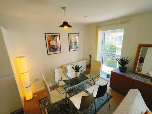 a living room with a glass table and chairs at Issara Apartments 49 - Great location & Private Parking in Portsmouth