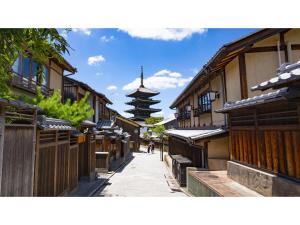 an alley with buildings and a pagoda in the background at Takatsuki W&M Hotel - Vacation STAY 02557v in Takatuki