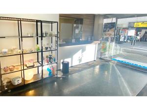 a store front with a display case in a store at Takatsuki W&M Hotel - Vacation STAY 02645v in Takatuki
