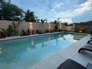 a swimming pool in a backyard with a fence at Casa Jubilee king suite 2 in Puerto Escondido