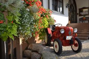 an old red car parked in front of a building at Hotel Riegeler Hof in Riegel am Kaiserstuhl