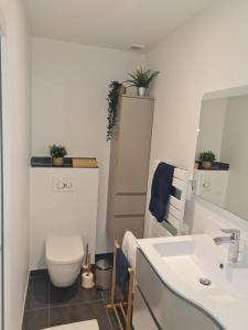 a bathroom with a toilet and a sink at Escale à Kergrenn in Fouesnant