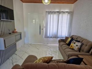 a living room with a couch and a window at Residencial Refúgio in Machadinho