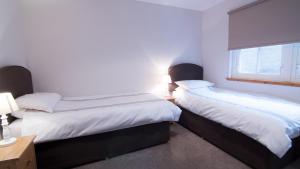 A bed or beds in a room at Morris Gardens Apartments 