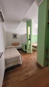 a bedroom with green and white walls and a bed at Manantiales Hotel Boutique in Victoria