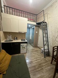 a room with a kitchen and a bunk bed at Sweet Guest House in Borjomi +7 photos