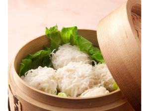 a wooden bowl filled with white rice and green lettuce at Asuka Hotel - Vacation STAY 59968v in Karatsu