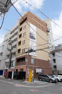 a tall building with a car parked in front of it at RIVER CENTRAL HIROSHIMA - Vacation STAY 59328v in Hiroshima