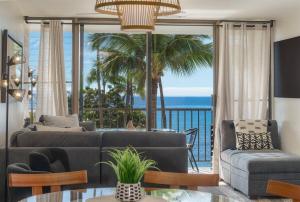 a living room with a view of the ocean at Chic Condo— Renovated & Refurnished 2023 / 2024 in Wailuku +16 photos