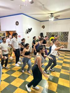 a group of people dancing in a room at Havana Dance School & Hostel in Cali