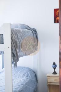 a bedroom with a bed with a gray blanket at Casa Parvati Chapadmalal in Chapadmalal