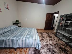 a bedroom with a bed with a blue and white blanket at Casa da Vila in Cáceres