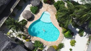 an overhead view of a swimming pool in a resort at The Garden in Paje
