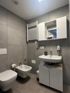 a bathroom with a toilet and a sink at LuganoApartment in Lugano