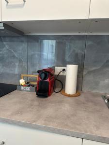 a red appliance sitting on top of a kitchen counter at LuganoApartment in Lugano