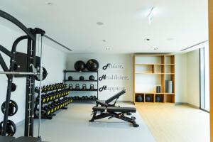 a gym with dumbbells and weights in a room at High-Rise Chic, Burj Crown, Opera Boulevard View, by Dubai Mall in Dubai